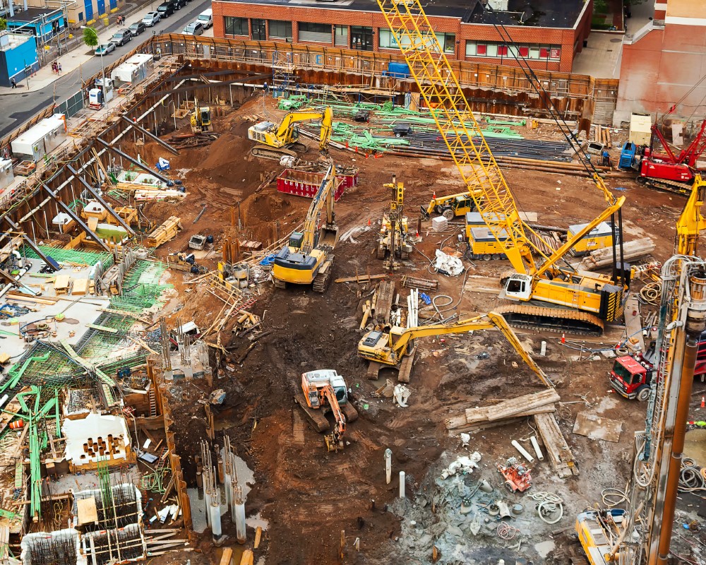 Engineer watching cranes at a building site
